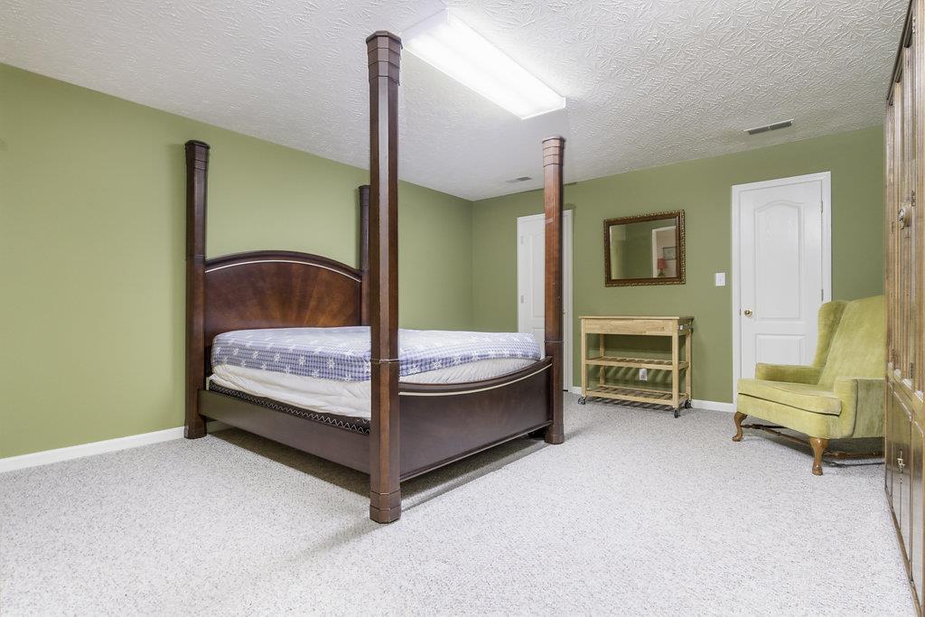 4010 Glen Raven Road Adams, TN 37010 - Photo 15 of 27 a bedroom with a bed chair and fireplace
