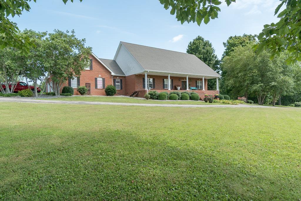 4010 Glen Raven Road Adams, TN 37010 - Photo 2 of 27 a front view of a house with a garden