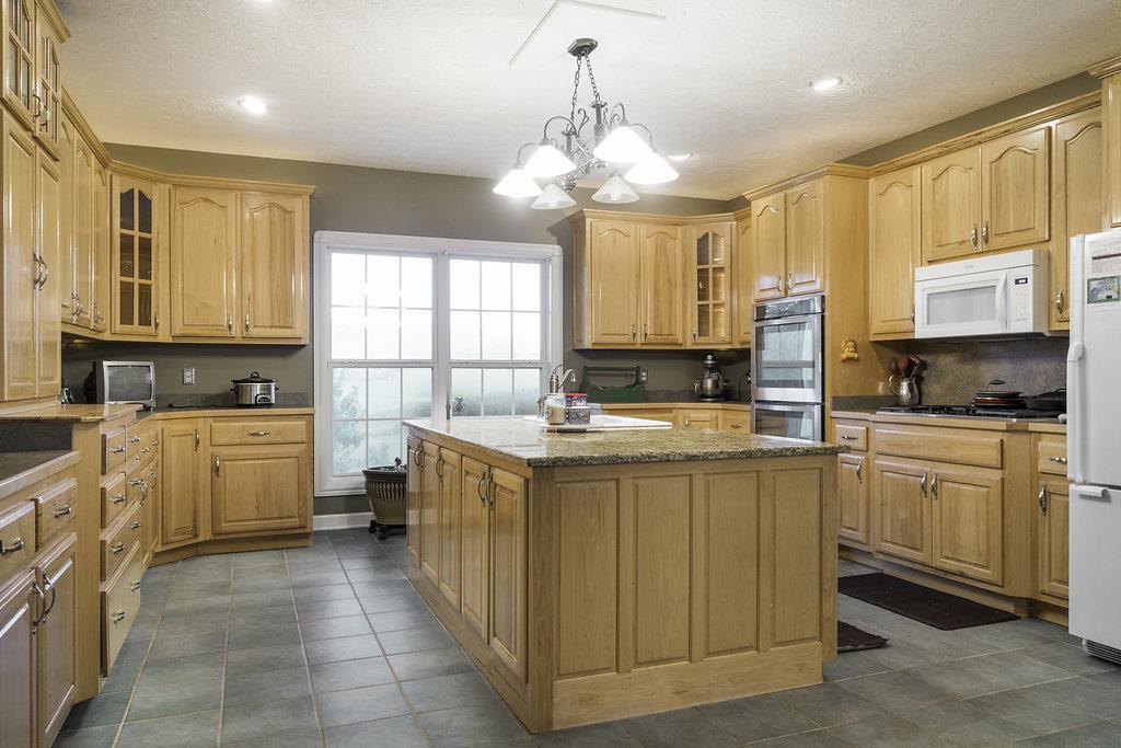 4010 Glen Raven Road Adams, TN 37010 - Photo 7 of 27 a kitchen with stainless steel appliances a sink stove cabinets and a window