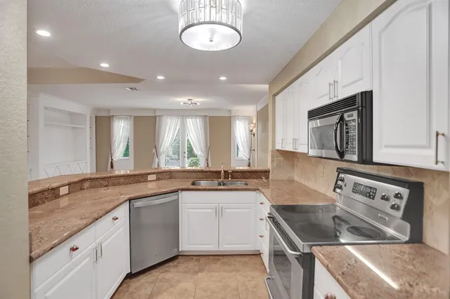 a kitchen with a sink stove and cabinets