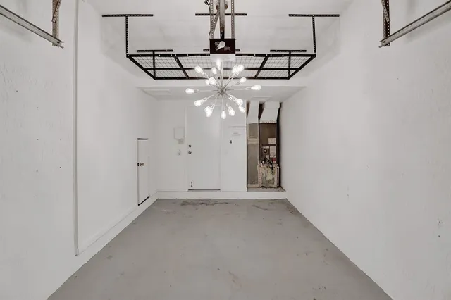 a view of a chandelier fan and entryway