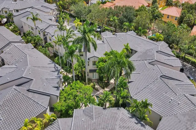 an aerial view of a house with a yard and garden