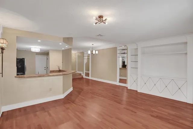 a view of a kitchen with wooden floor and a kitchen