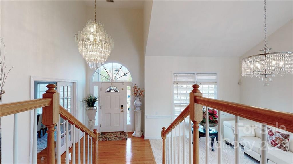 218 Chesterfield Canal Fort Mill, SC 29708 - Photo 18 of 40 a view of a hallway with entryway wooden floor and chandelier