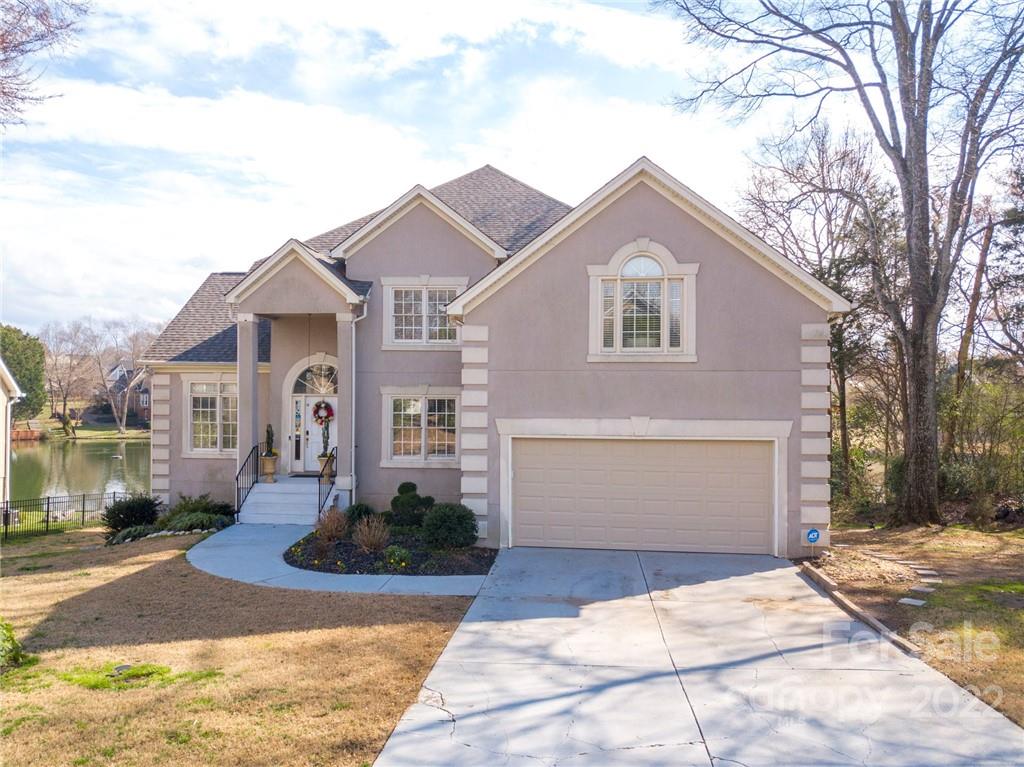 218 Chesterfield Canal Fort Mill, SC 29708 - Photo 2 of 40 a front view of a house with a yard and garage