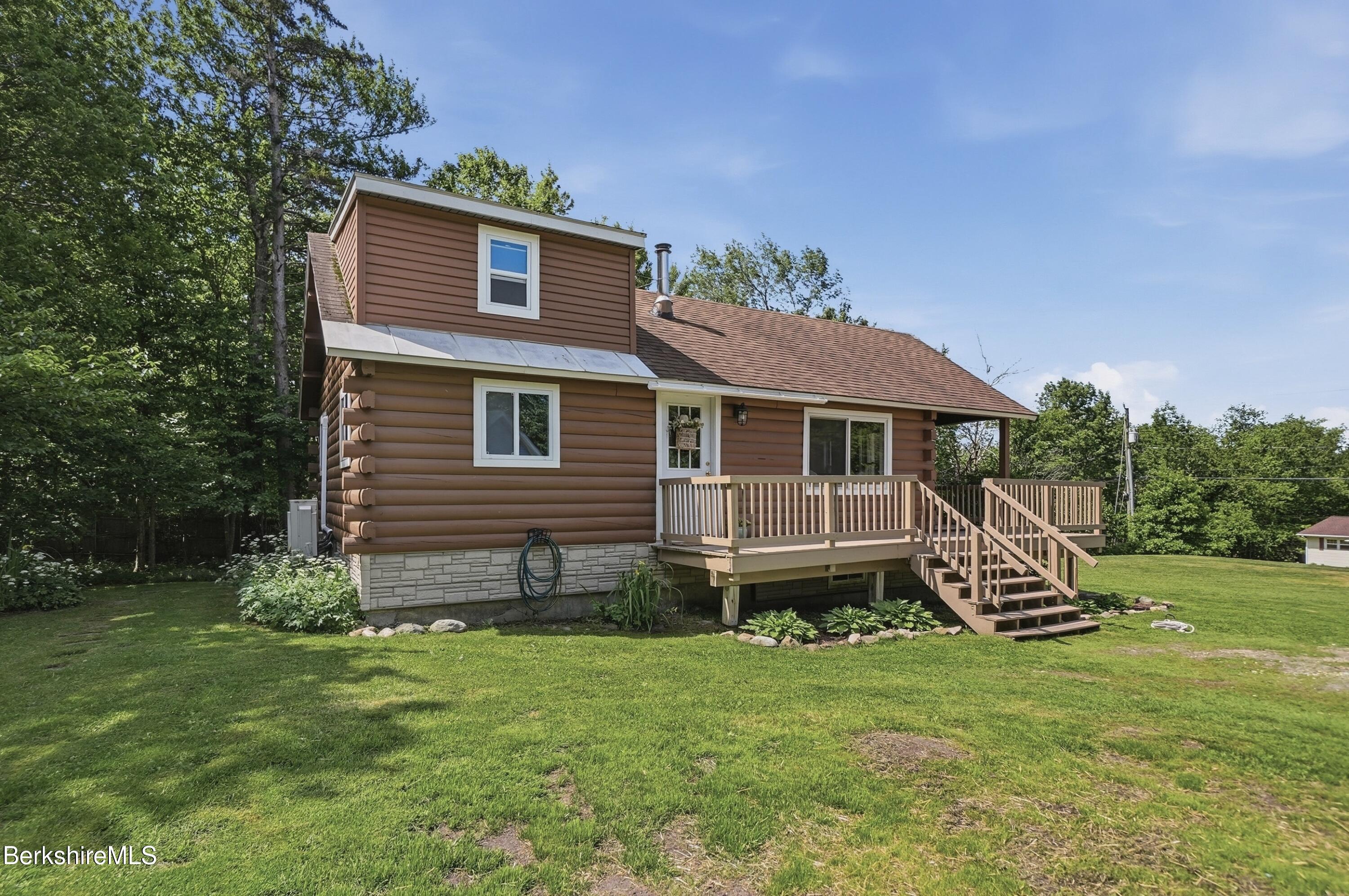 4 David Drive Peru, MA 01235 - Photo 3 of 44 a front view of a house with a yard