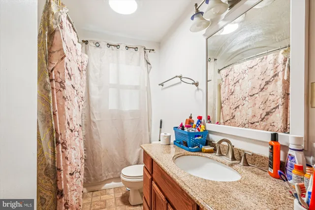 a view of a room with furniture and a window