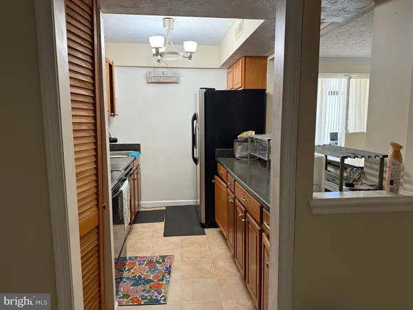 a hallway with cabinets and chandelier