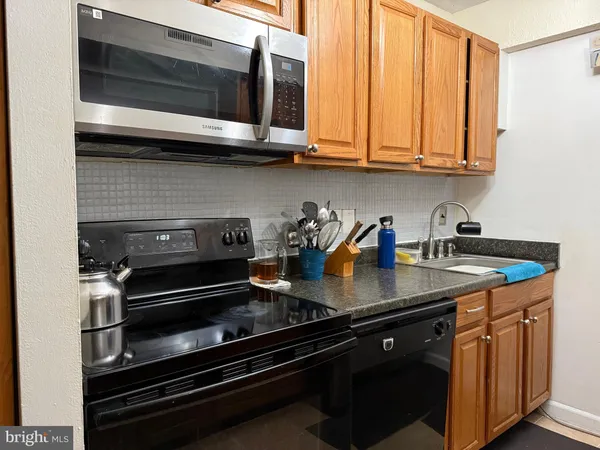 a kitchen with stainless steel appliances granite countertop a sink and cabinets