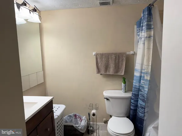 a white toilet sitting next to a bathroom sink and a toilet