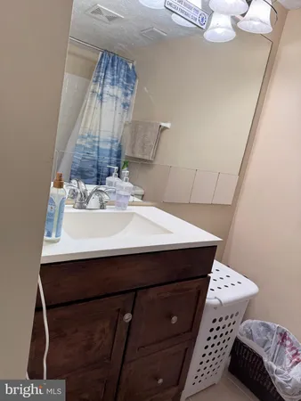 a bathroom with a sink vanity and a mirror
