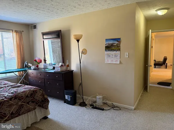 a bedroom with a bed and a mirror