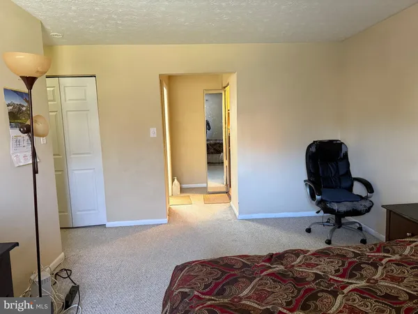 a bedroom with a bed and a chair