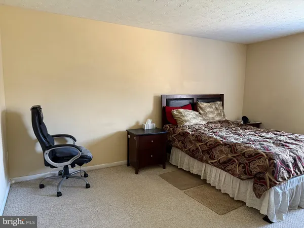 a bedroom with a bed and a chair