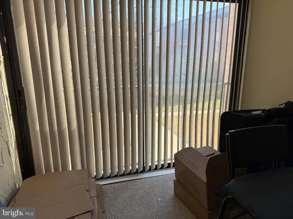 a living room with furniture lamp and a window