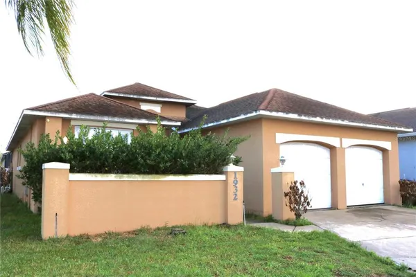 a view of a house with a yard and sitting area