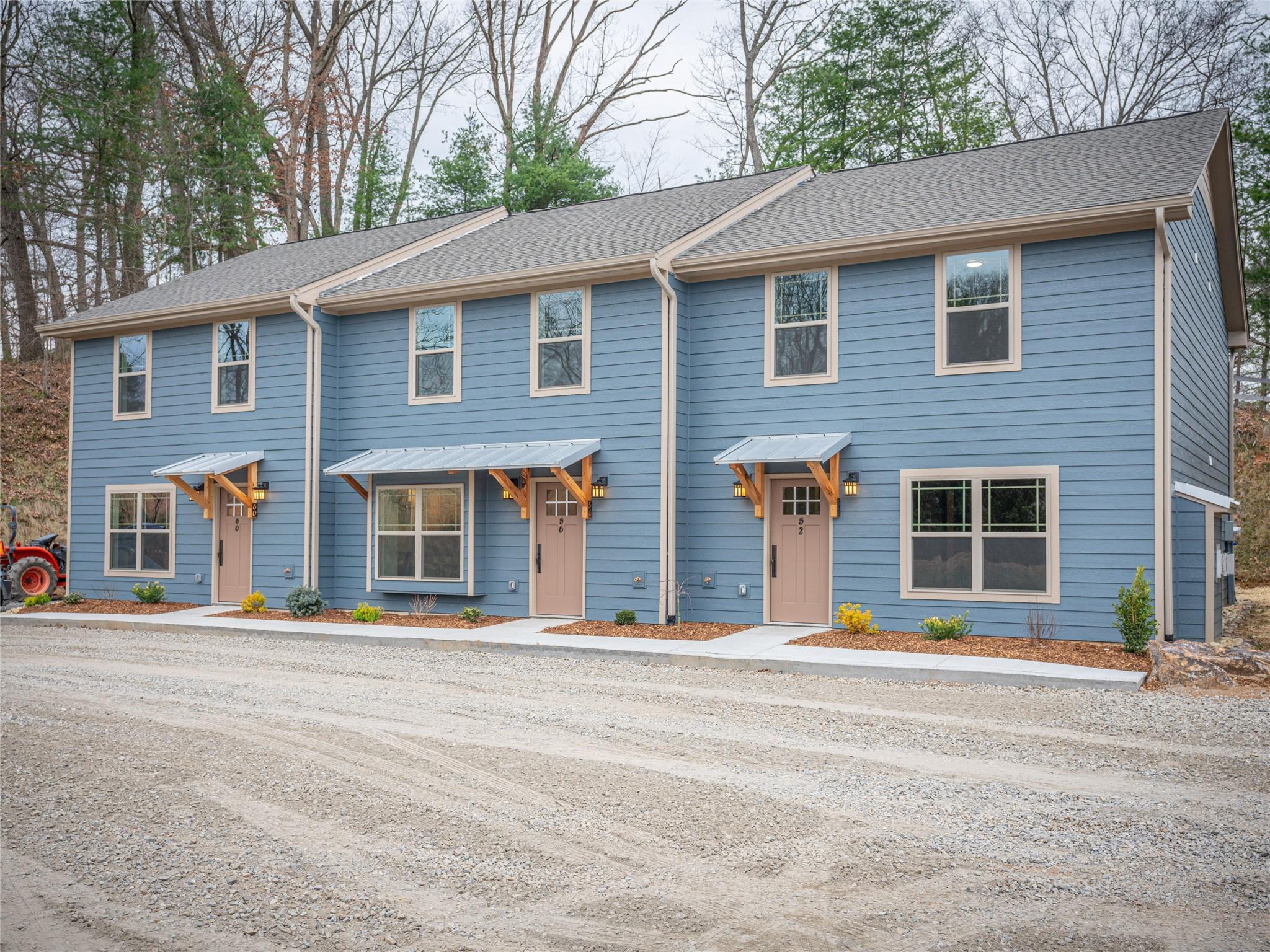 a front view of a house with a road