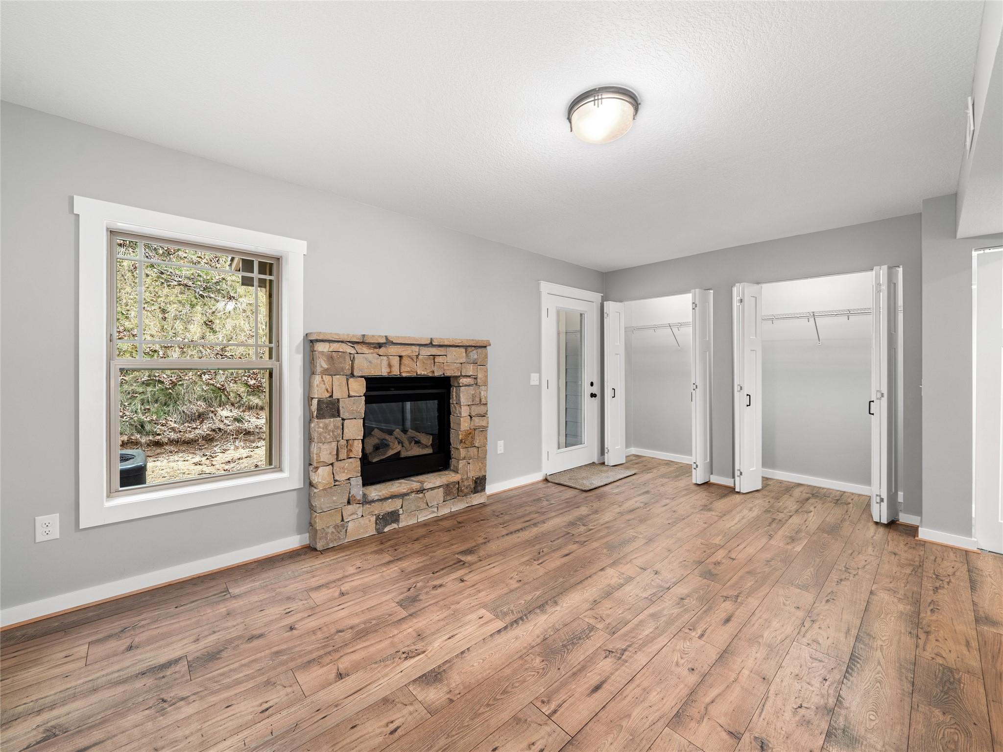 56 Trevor Trail Clyde, NC 28721 - Photo 11 of 27 a view of empty room with wooden floor and fireplace