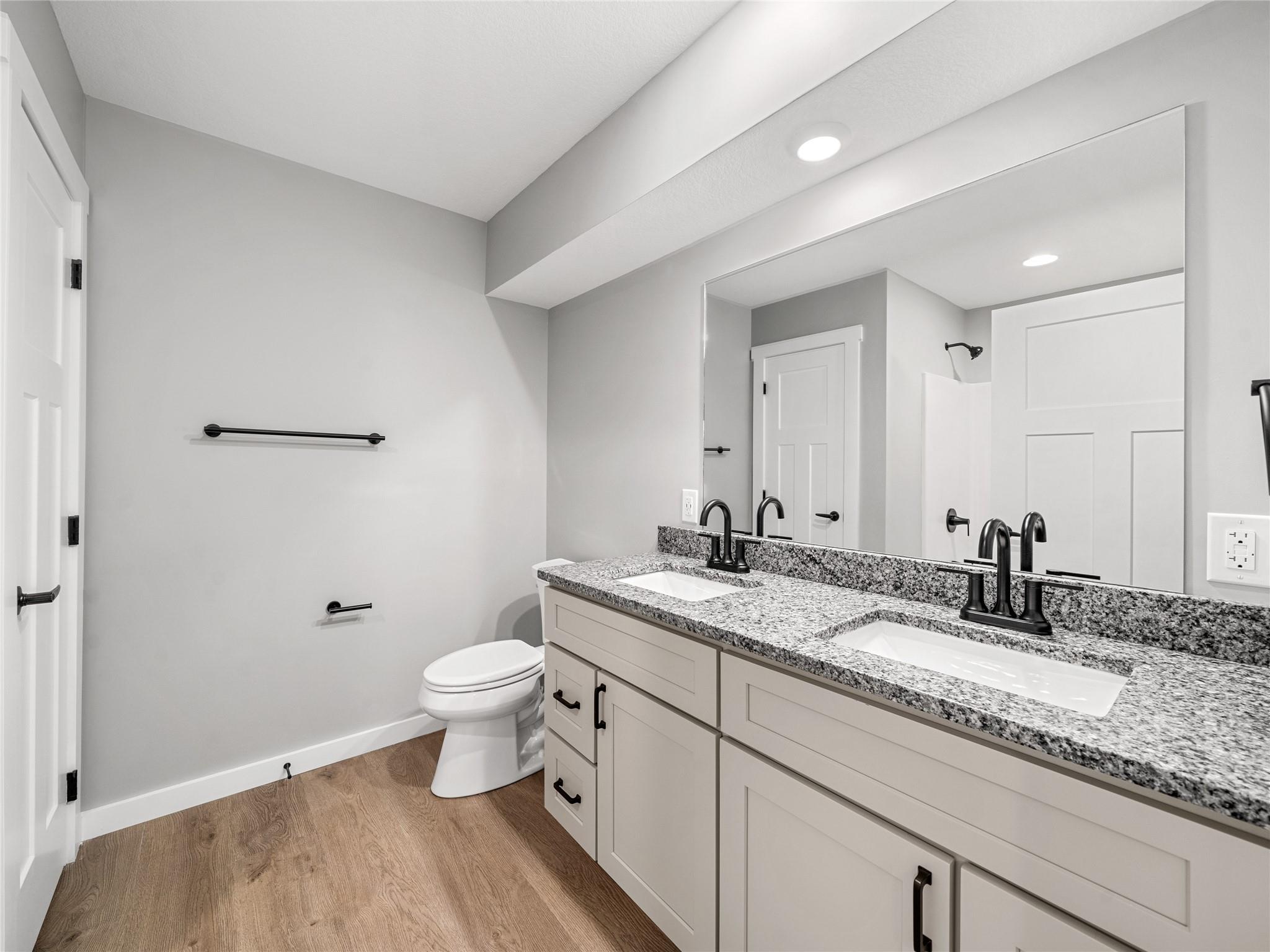 56 Trevor Trail Clyde, NC 28721 - Photo 12 of 27 a bathroom with a granite countertop sink a toilet and a mirror