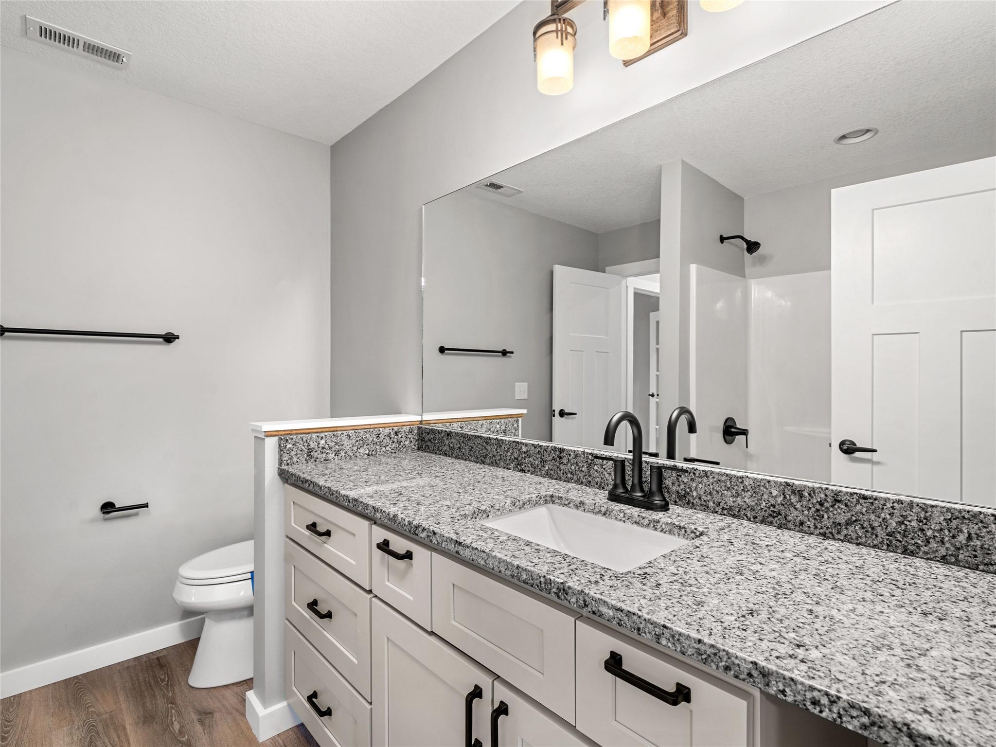 56 Trevor Trail Clyde, NC 28721 - Photo 17 of 27 a bathroom with a granite countertop sink and a mirror