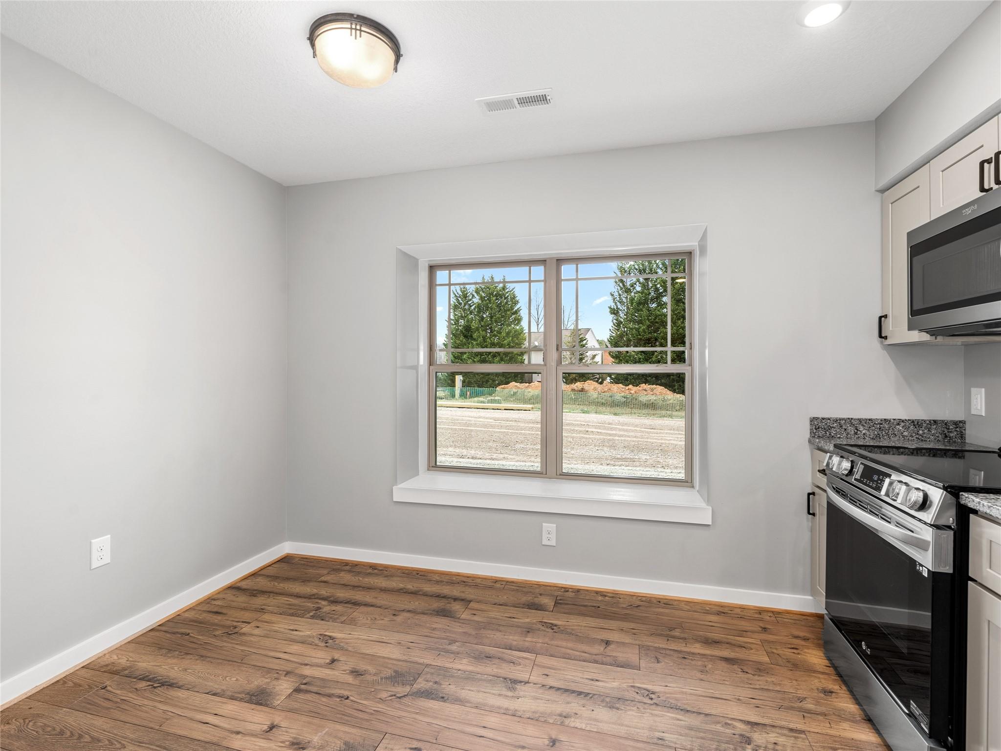 56 Trevor Trail Clyde, NC 28721 - Photo 6 of 27 a view of an empty room with a window and wooden floor