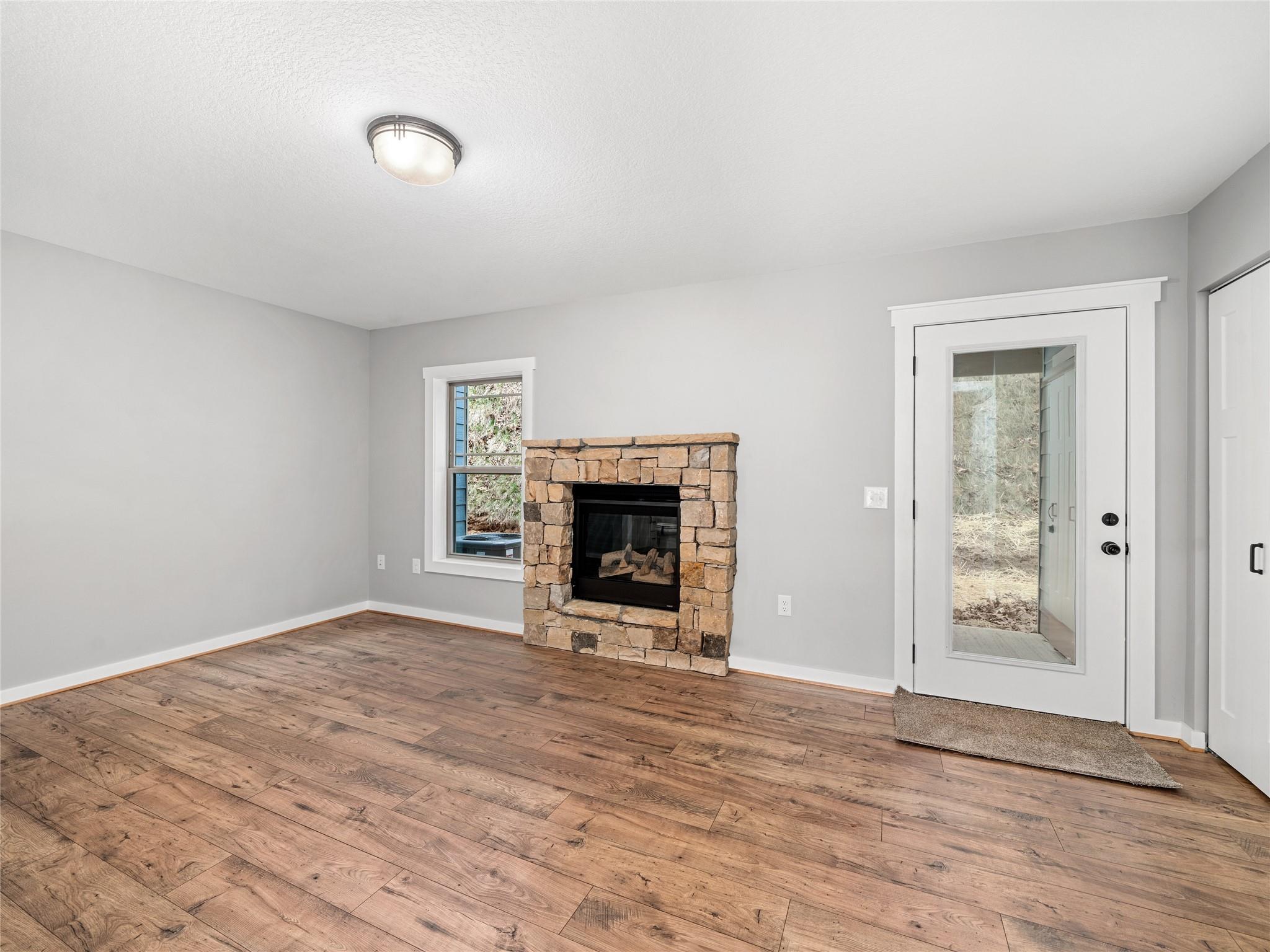 56 Trevor Trail Clyde, NC 28721 - Photo 10 of 27 a view of an empty room with wooden floor fireplace and a window