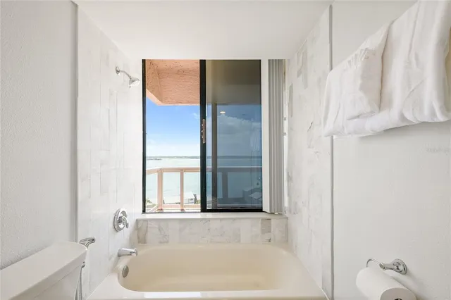 a bathroom with a tub and shower