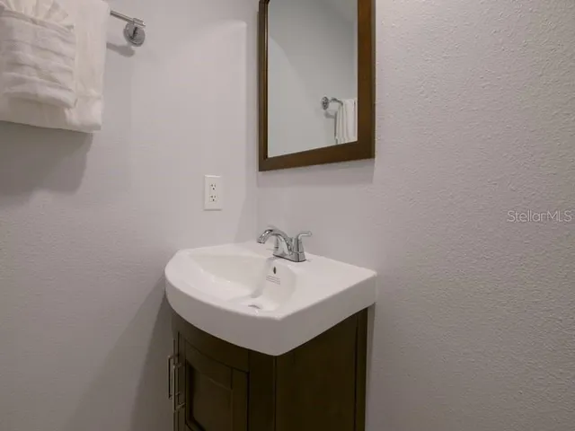 a bathroom with a sink and a mirror
