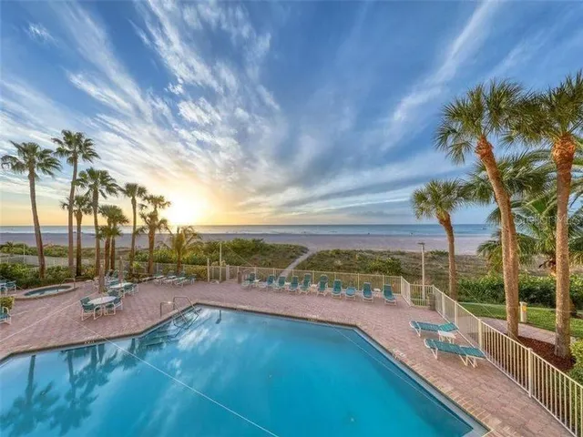 a view of a swimming pool with a lake view and sitting space