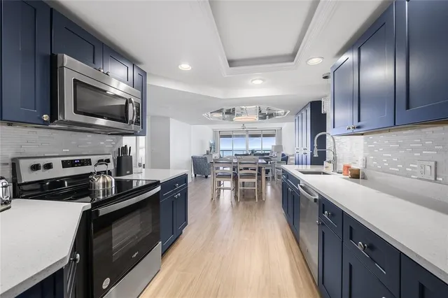 a kitchen with a sink stove and microwave