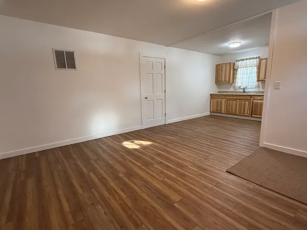 a view of wooden floor and windows in a room