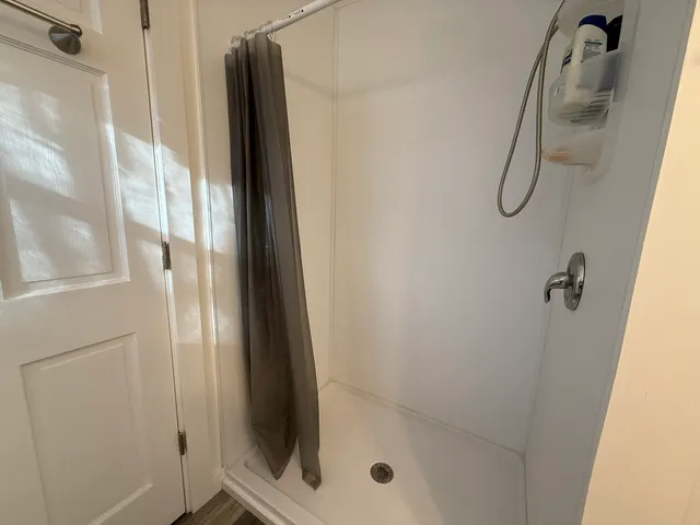a bathroom with a glass shower door