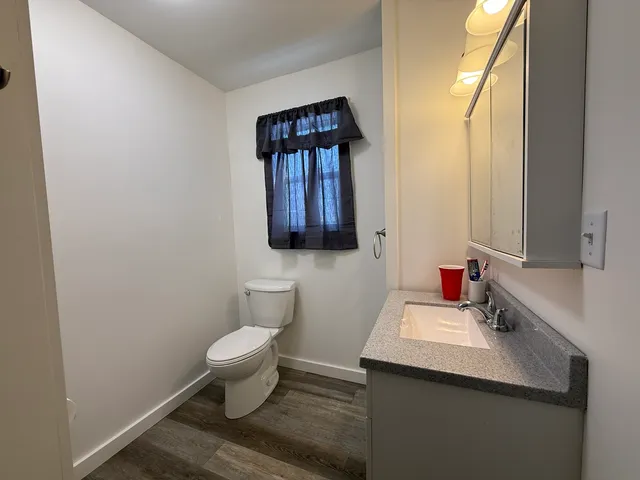 a bathroom with a toilet sink and mirror
