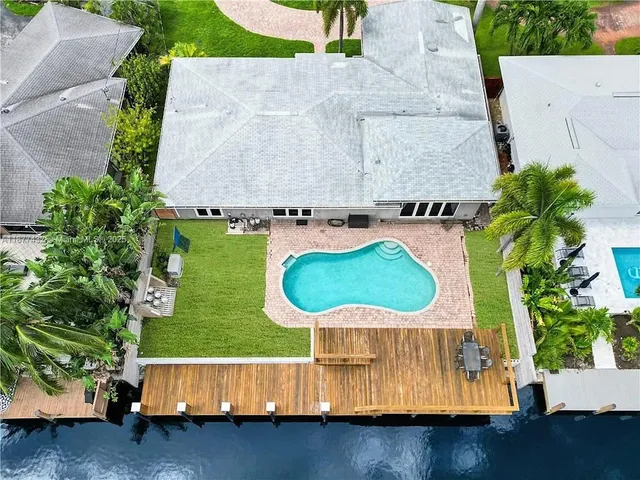 an aerial view of a house with yard swimming pool and outdoor seating