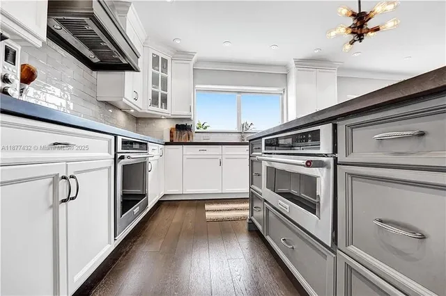 a kitchen with stainless steel appliances a white stove top oven and sink