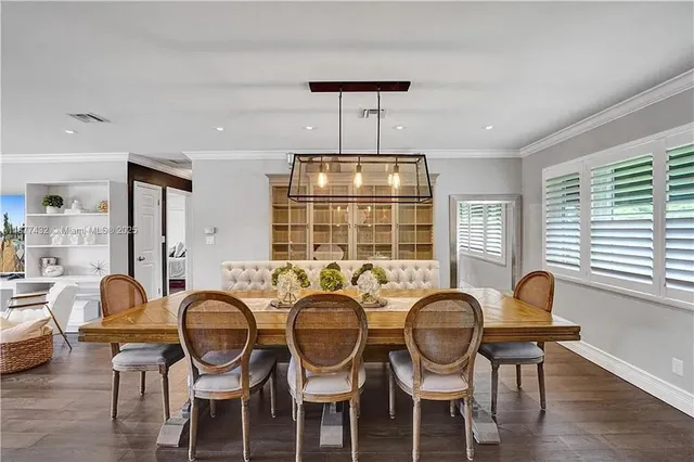 a view of a dining room with furniture wooden floor and chandelier