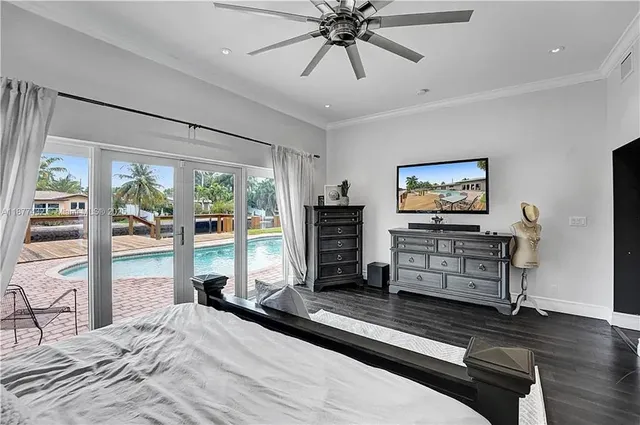 a bedroom with furniture and a flat screen tv