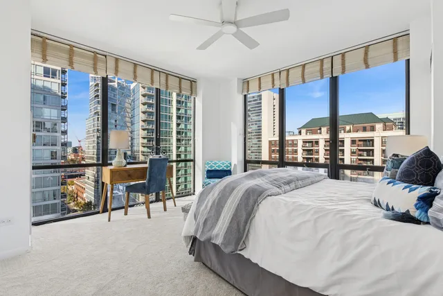 a large bedroom with a large bed and a balcony view