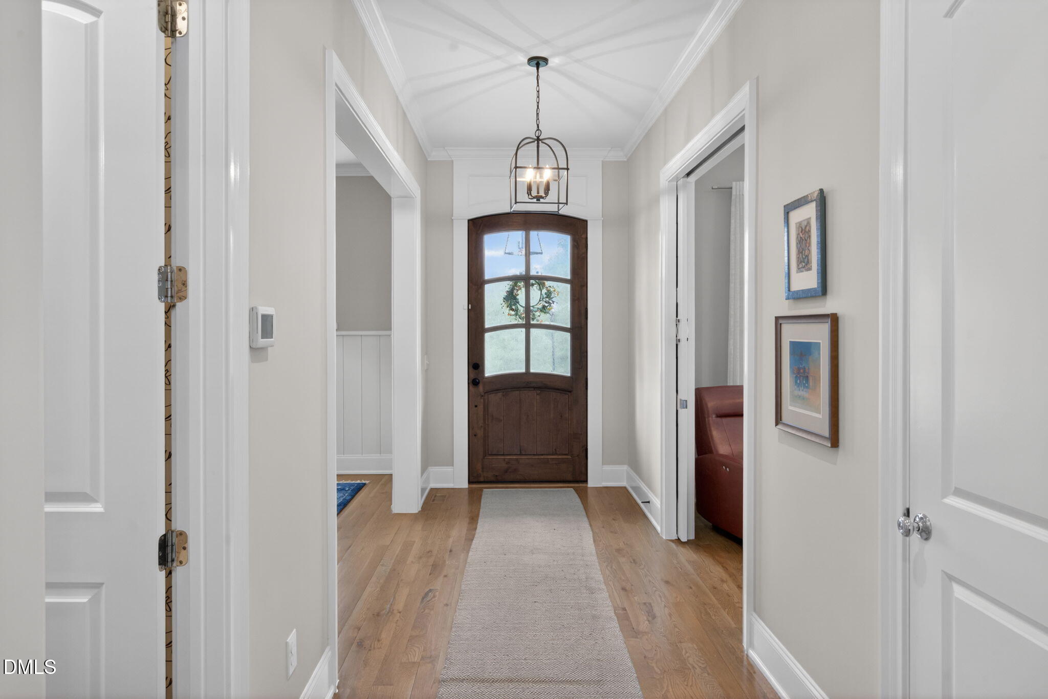 6901 Ray Family Farm Court Raleigh, NC 27613 - Photo 3 of 52 a view of a hallway with windows and chandelier
