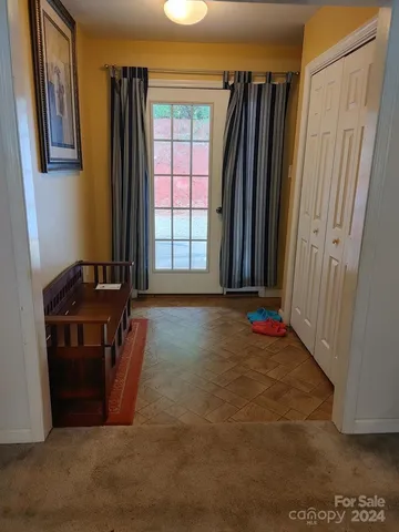 a view of a room with furniture and a window