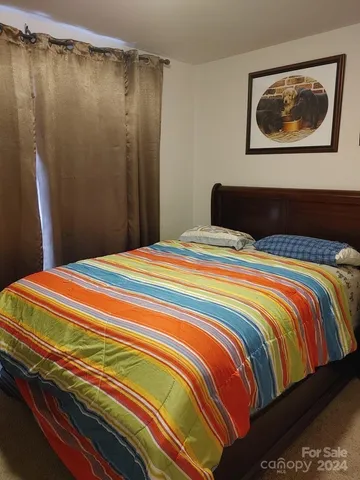 a bedroom with a bed and cupboard