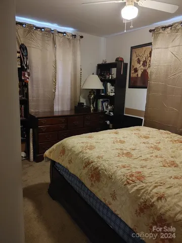 a bed sitting in a bedroom next to a bathroom sink