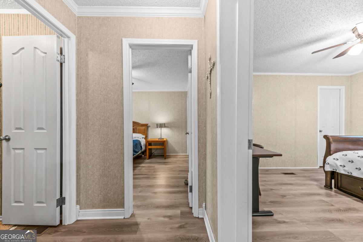 194 Phillips Road Eatonton, GA 31024 - Photo 27 of 57 a view of a bedroom from a hallway