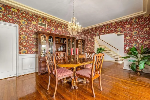 a view of a room with wooden floor and a potted plant