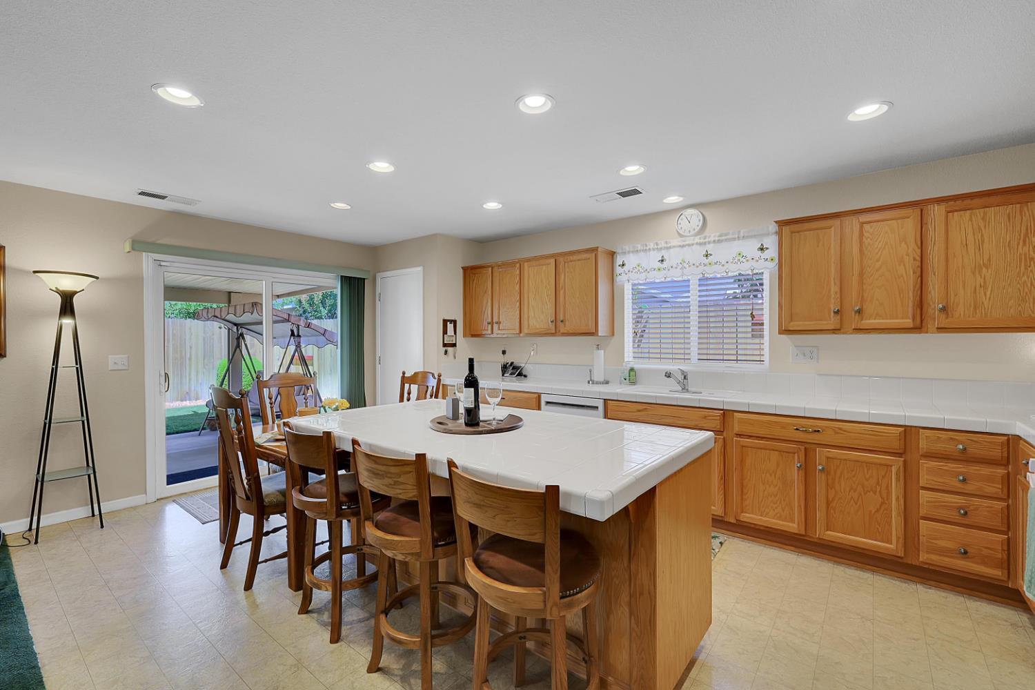 9840 Ellis Way Live Oak, CA 95953 - Photo 24 of 44 a kitchen with stainless steel appliances granite countertop table chairs sink and stove