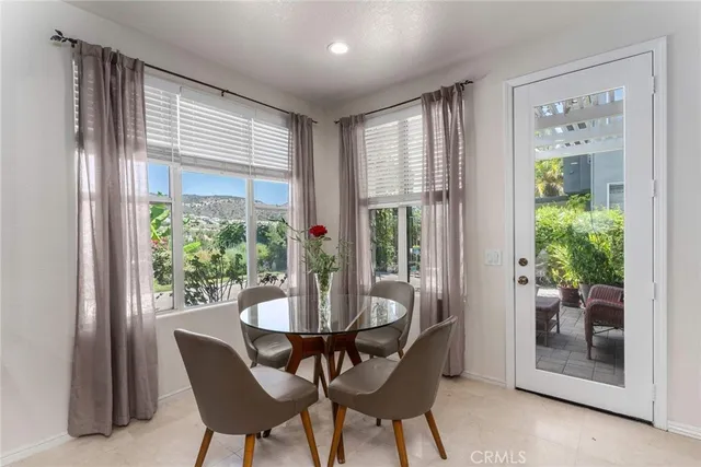 a dining room with furniture and windows