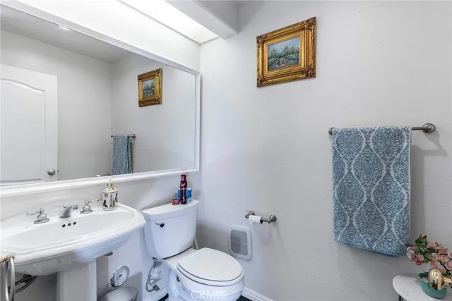 a bathroom with a sink mirror and toilet