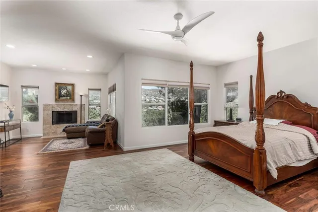 a bedroom with a bed couch and a large window