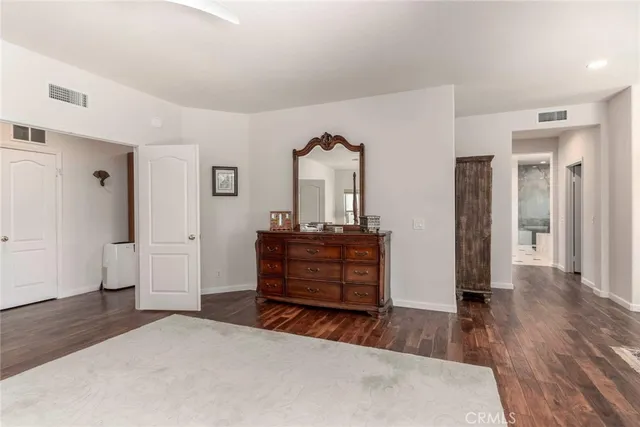 a room with a bed and a mirror