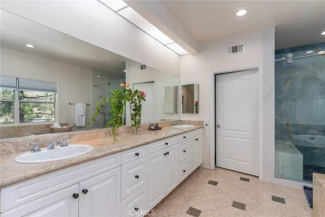a bathroom with a granite countertop sink mirror and toilet